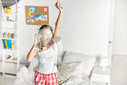 Image of happy woman in headphones having fun at home