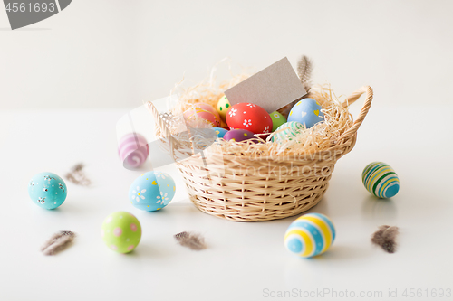 Image of easter eggs and greeting card in basket