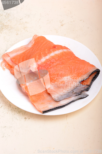 Image of fresh salmon fillet close up on white plate