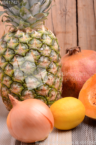 Image of collection of fruit and vegetables. Pineapple, lemon, grapefruit, onion, pumpkin