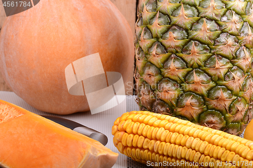 Image of collection of fruit and vegetables. Pineapple, corn, pumpkin, orange