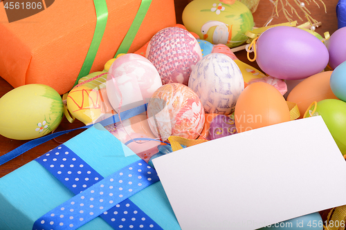 Image of Arrangement of Gift Boxes in Wrapping Paper with Checkered Ribbons and Decorated Easter Eggs