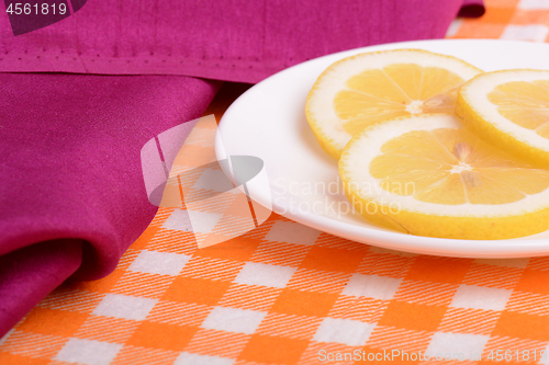 Image of Lemon sliced lies on a plate shaped