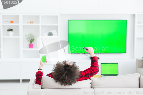 Image of young man in bathrobe enjoying free time