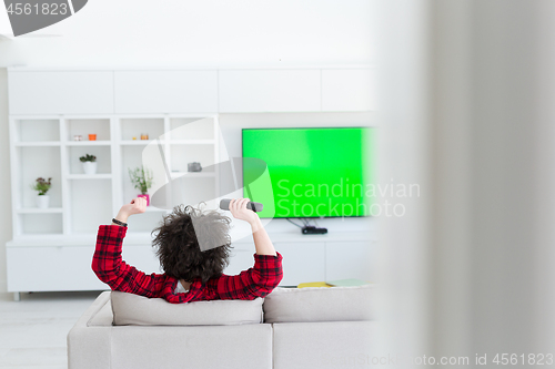 Image of young man in bathrobe enjoying free time