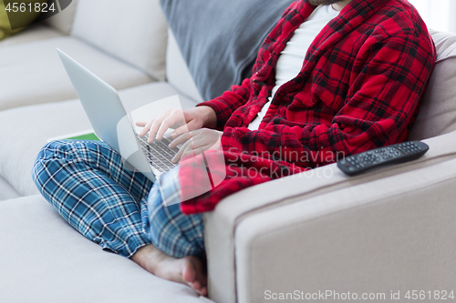 Image of man freelancer in bathrobe working from home
