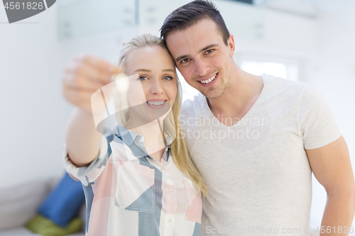 Image of couple showing a keys of their new house