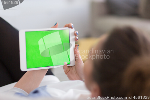Image of woman on sofa using tablet computer