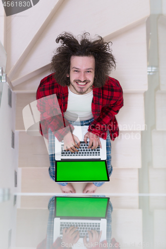 Image of freelancer in bathrobe working from home