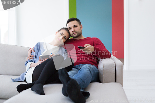 Image of Young couple on the sofa watching television