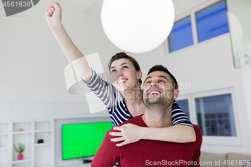 Image of handsome man piggybacking his girlfriend