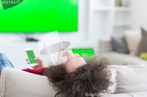 Image of young man in bathrobe enjoying free time