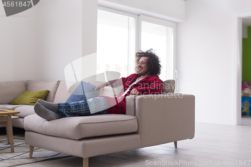 Image of young man in bathrobe enjoying free time