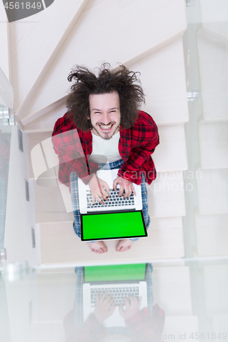 Image of freelancer in bathrobe working from home