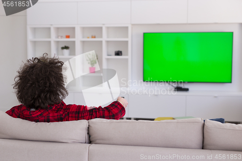 Image of young man in bathrobe enjoying free time