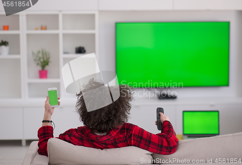 Image of young man in bathrobe enjoying free time