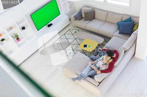 Image of Young couple on the sofa watching television