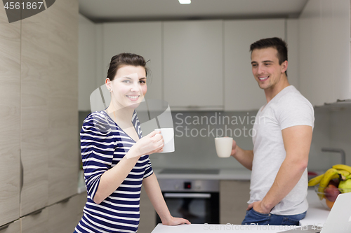 Image of couple with laptop computer enjoying morning