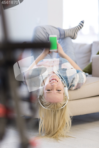 Image of girl enjoying music through headphones