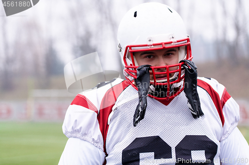 Image of portrait of young confident American football player