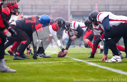 Image of professional american football players ready to start