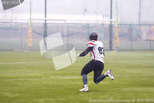 Image of American football player running on the field