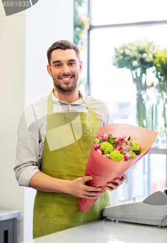 Image of smiling florist man with bunch at flower shop