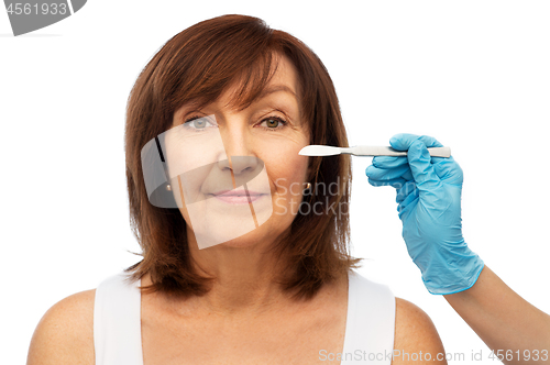 Image of senior woman and surgeon hands with scalpel