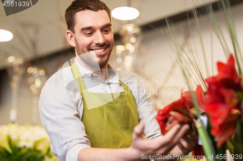 Image of florist or seller with amaryllis at flower shop