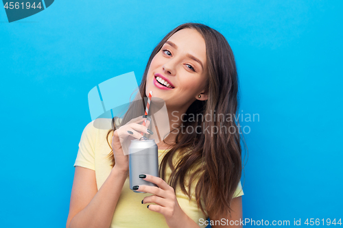 Image of young woman or teenage girl drinking soda from can