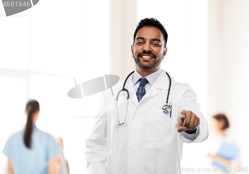 Image of smiling indian male doctor pointing finger to you