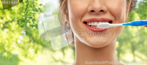 Image of close up of woman with toothbrush cleaning teeth