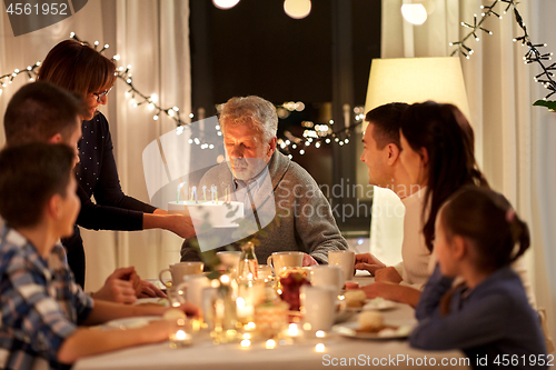 Image of happy family having birthday party at home