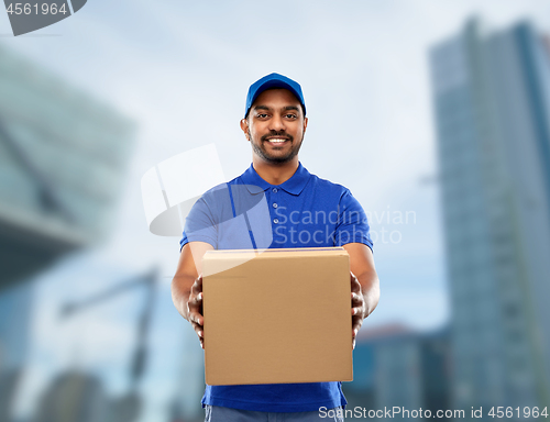 Image of happy indian delivery man with parcel box in blue