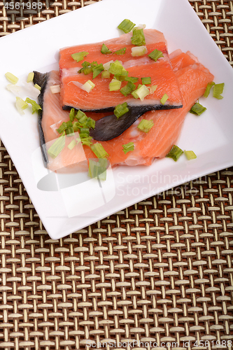 Image of fresh salmon fillet close up on white plate