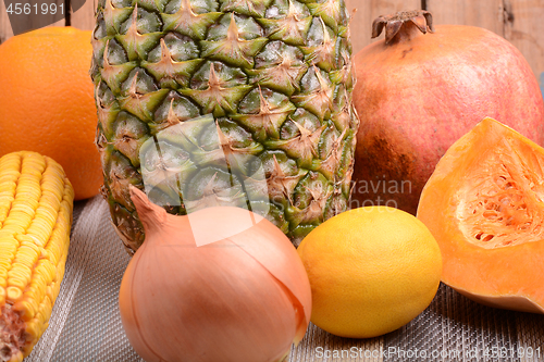 Image of collection of fruit and vegetables. Pineapple, lemon, grapefruit, onion, corn, pumpkin, orange