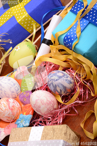 Image of Arrangement of Gift Boxes in Wrapping Paper with Checkered Ribbons and Decorated Easter Eggs