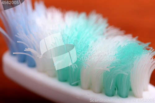 Image of xtreme Macro close up of toothbrush with wooden background