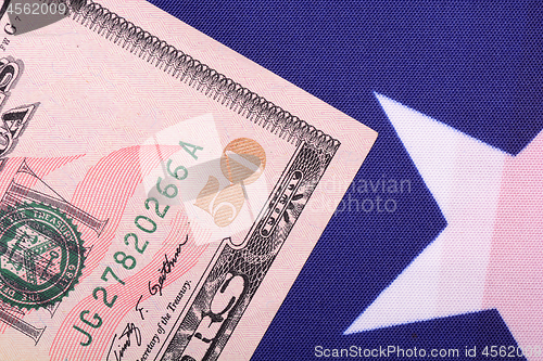 Image of fifty dollar bill in front of the American flag