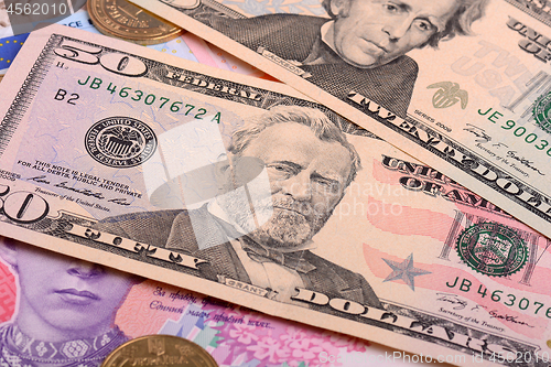 Image of american dollars and ukrainian grivna pile as background