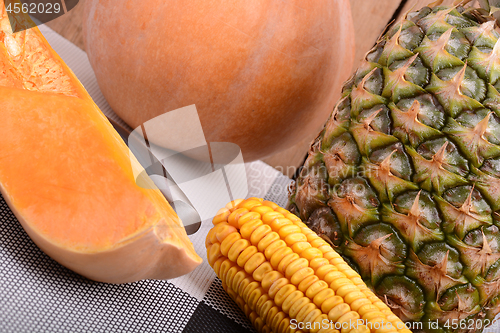 Image of collection of fruit and vegetables. Pineapple, corn, pumpkin, orange