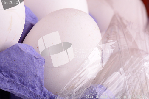 Image of close up of white eggs in cardboard container