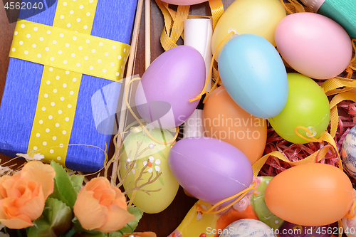 Image of Arrangement of Gift Boxes in Wrapping Paper with Checkered Ribbons and Decorated Easter Eggs