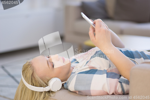 Image of girl enjoying music through headphones