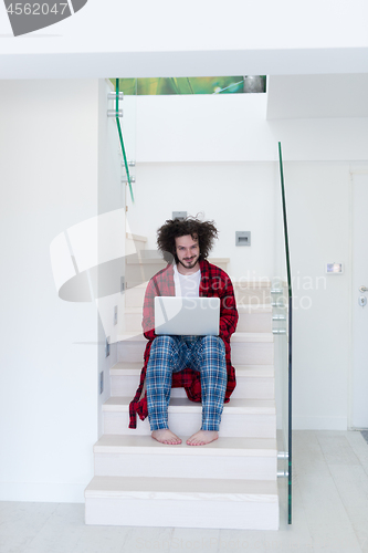 Image of freelancer in bathrobe working from home