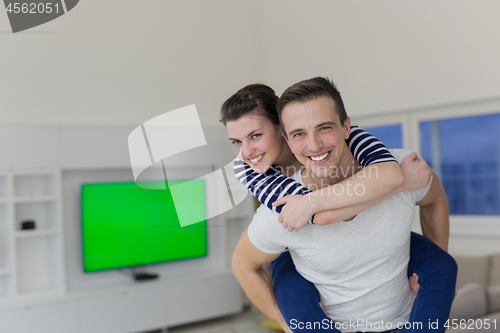 Image of handsome man piggybacking his girlfriend