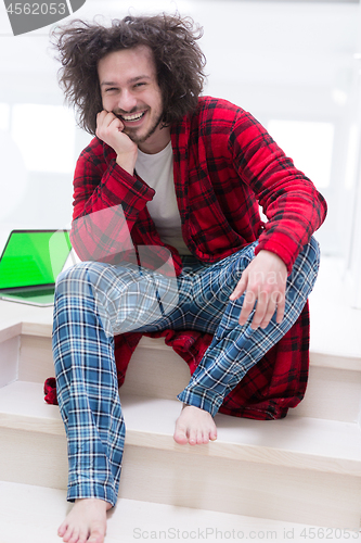 Image of freelancer in bathrobe working from home