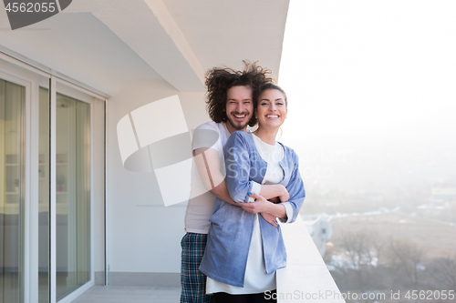 Image of Couple hugging on the balcony