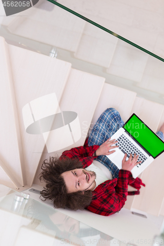 Image of freelancer in bathrobe working from home