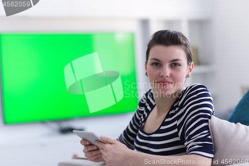 Image of woman on sofa using tablet computer